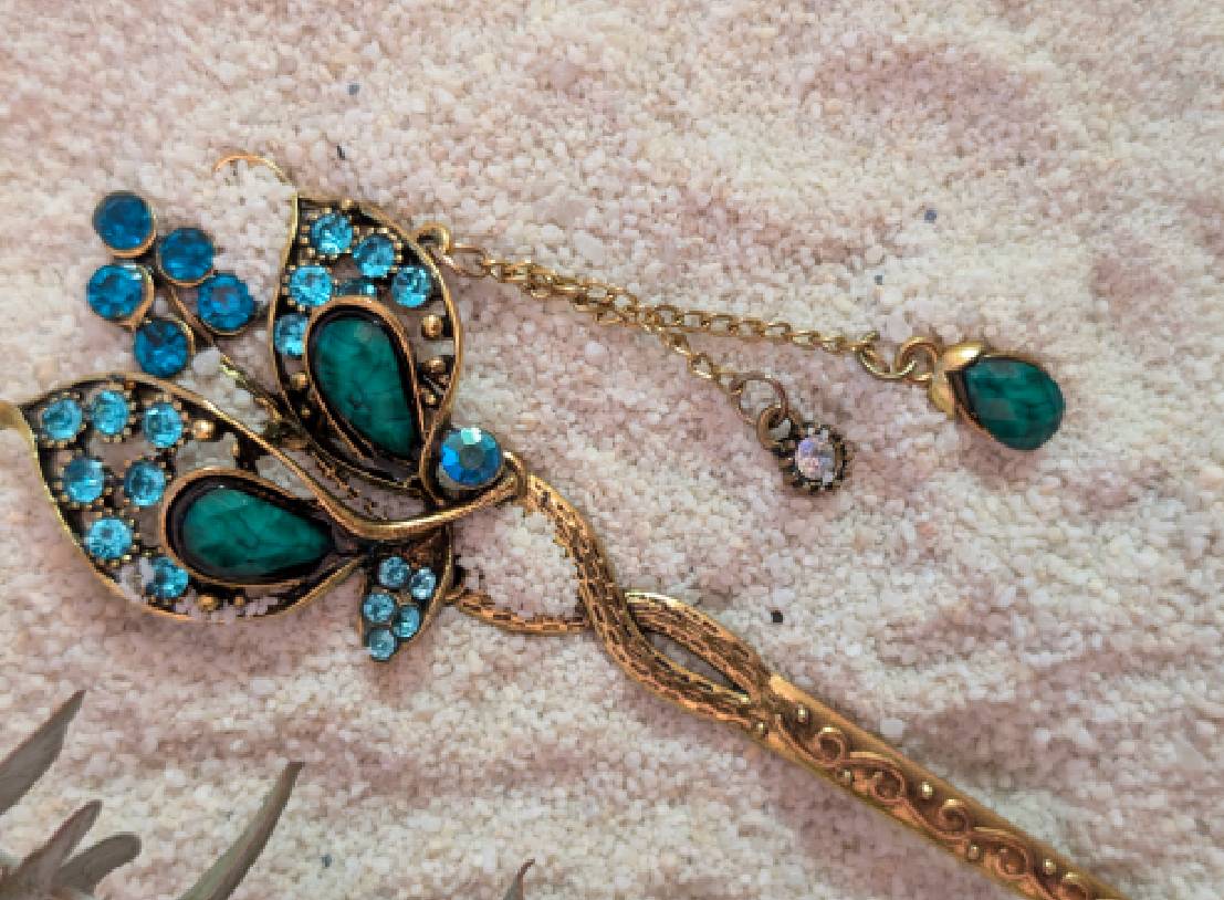 Gold butterfly hairpin with teal gemstones
