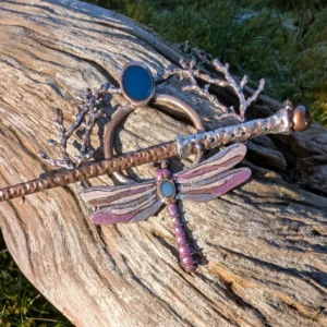 Decorative dragonfly hair stick on driftwood